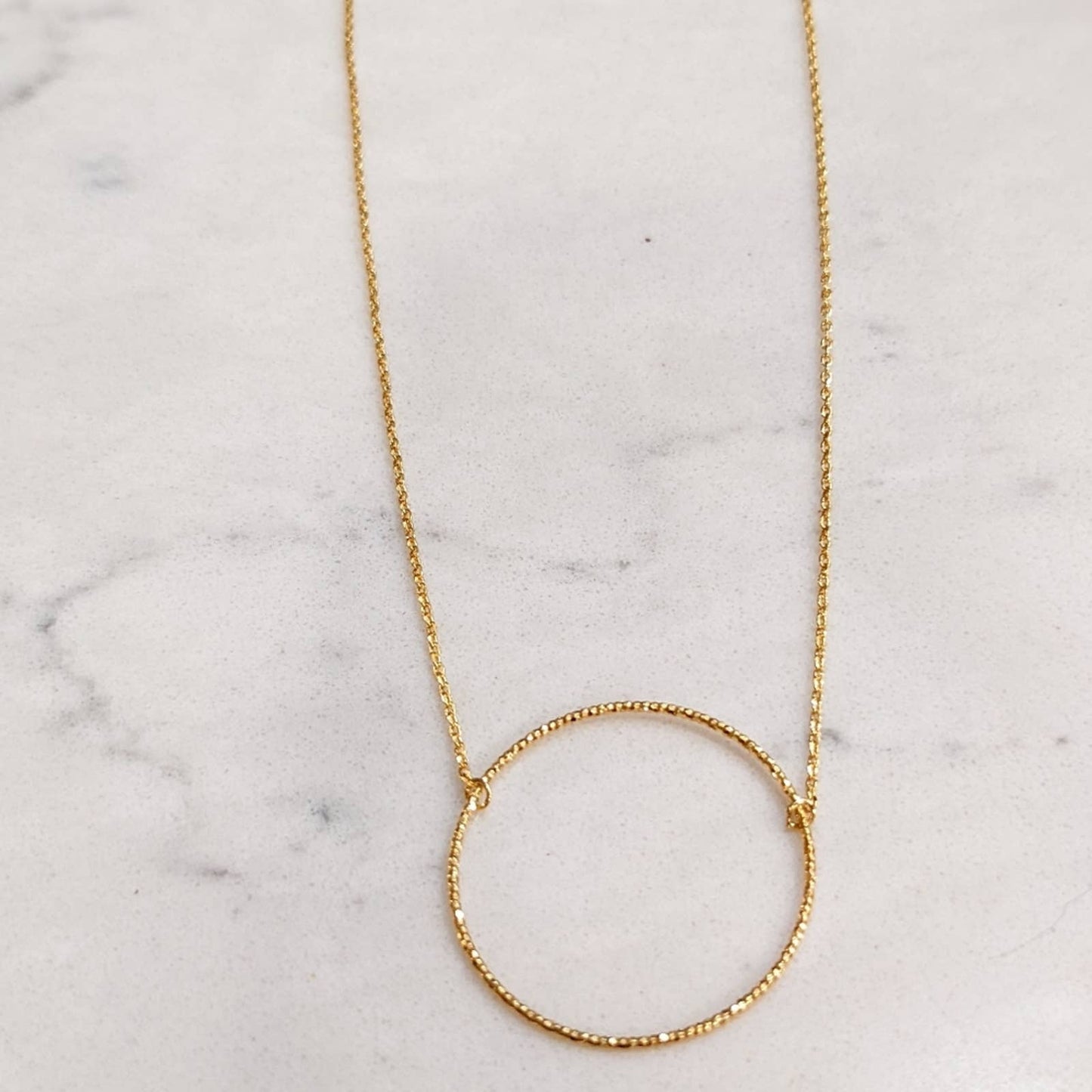 Dainty Gold Circle Necklace with a Hint of Sparkle