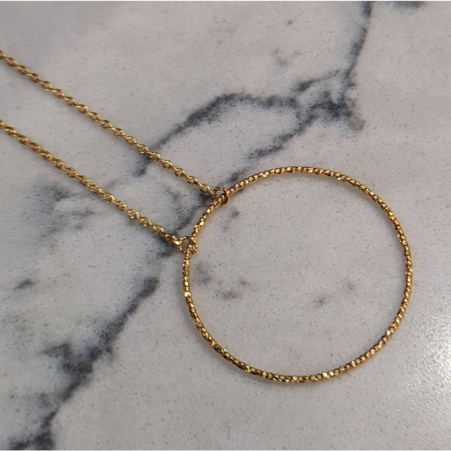 Dainty Gold Circle Necklace with a Hint of Sparkle