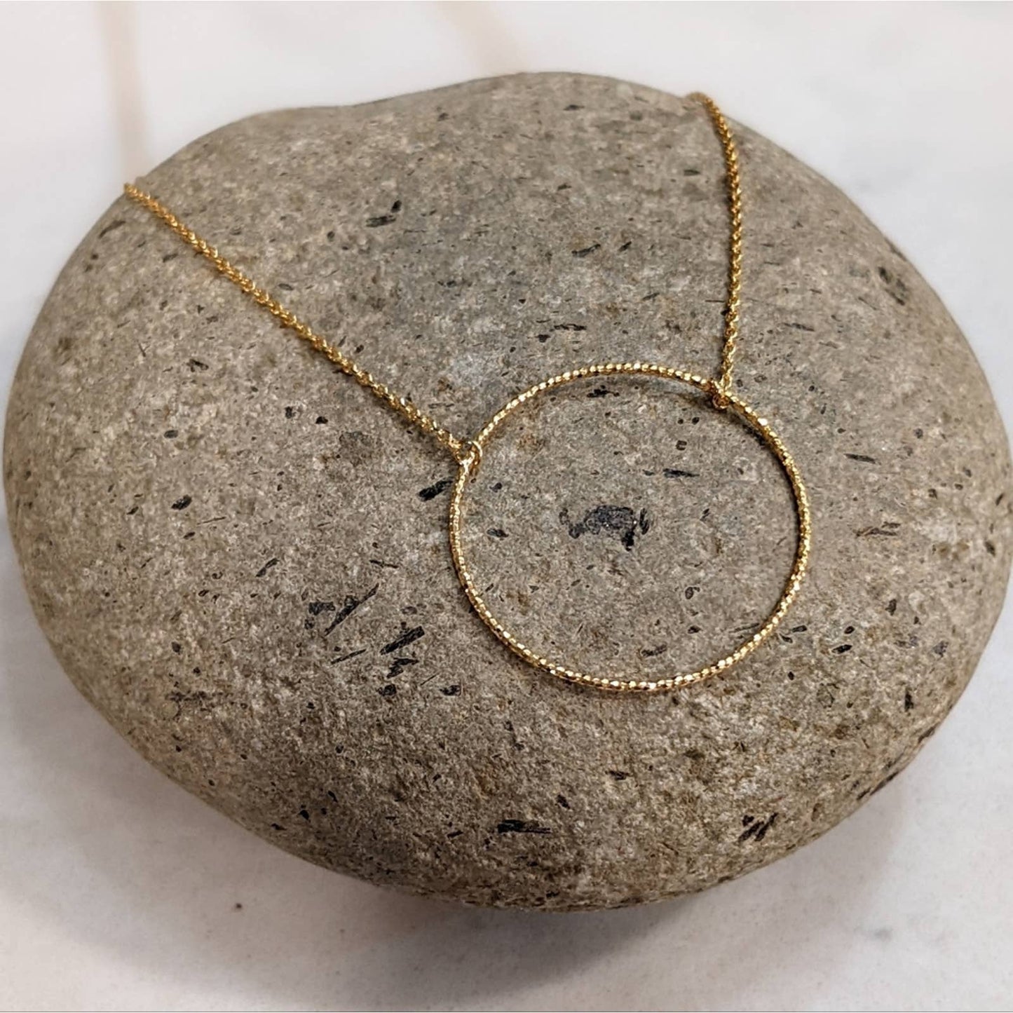Dainty Gold Circle Necklace with a Hint of Sparkle