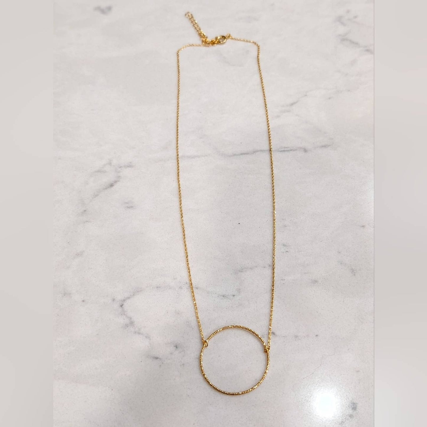 Dainty Gold Circle Necklace with a Hint of Sparkle