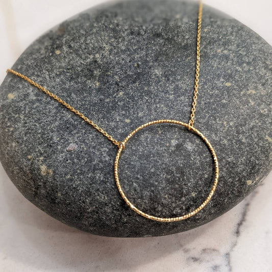 Dainty Gold Circle Necklace with a Hint of Sparkle